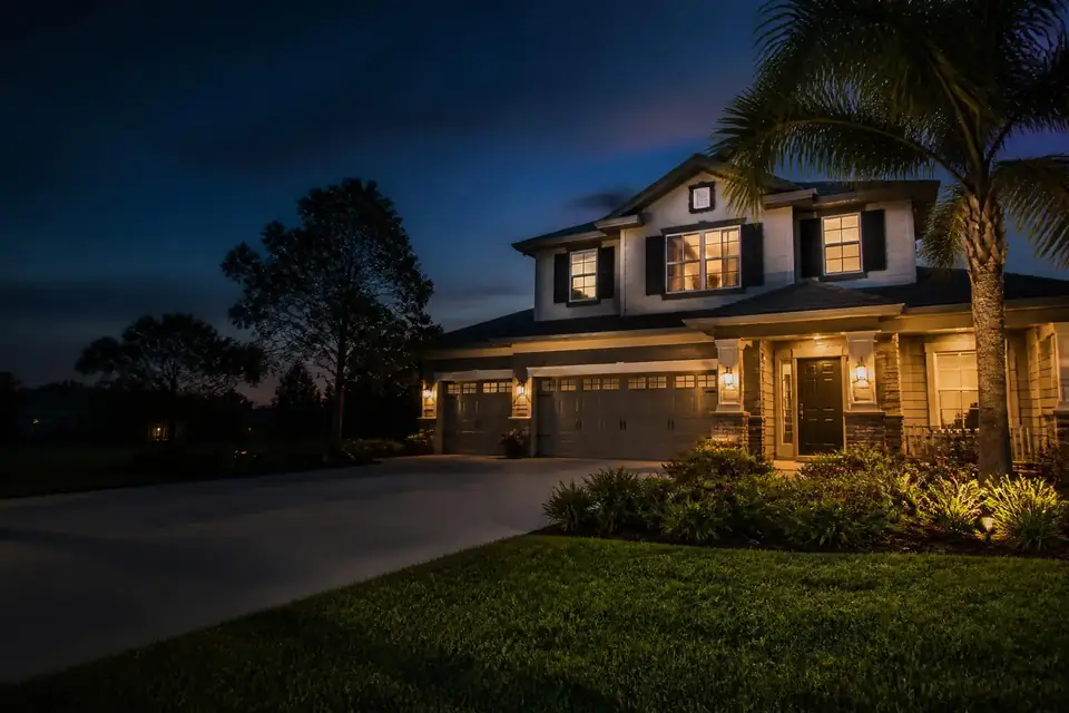 Florida home at dusk with warm interior lighting